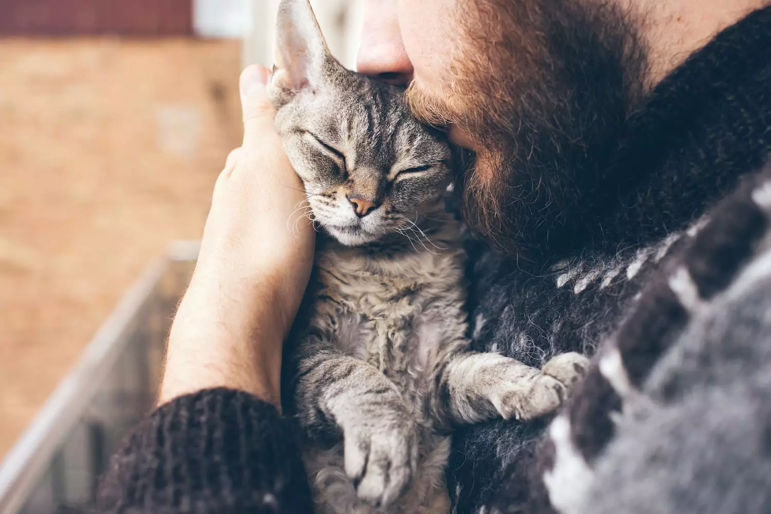 man holding his cat tightly