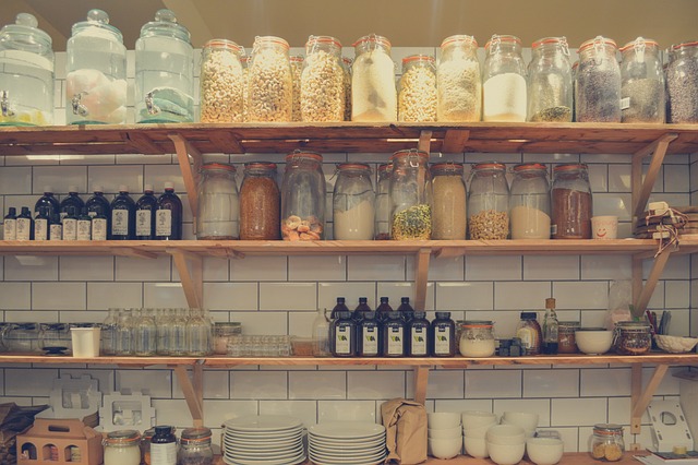 A scene of properly stored food in jars on shelves -- an essential component to  mouse prevention