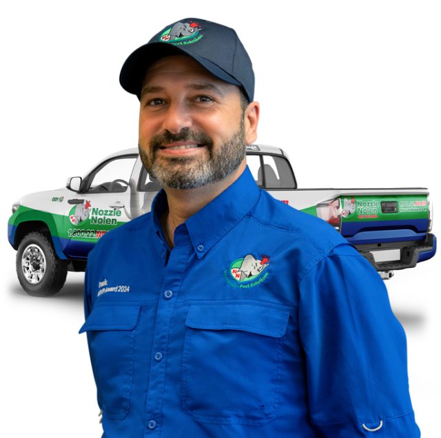 A man in a blue uniform and cap smiles, standing in front of a branded pickup truck with "Nozzle Nolen" logos. The truck features pest control imagery and contact details.